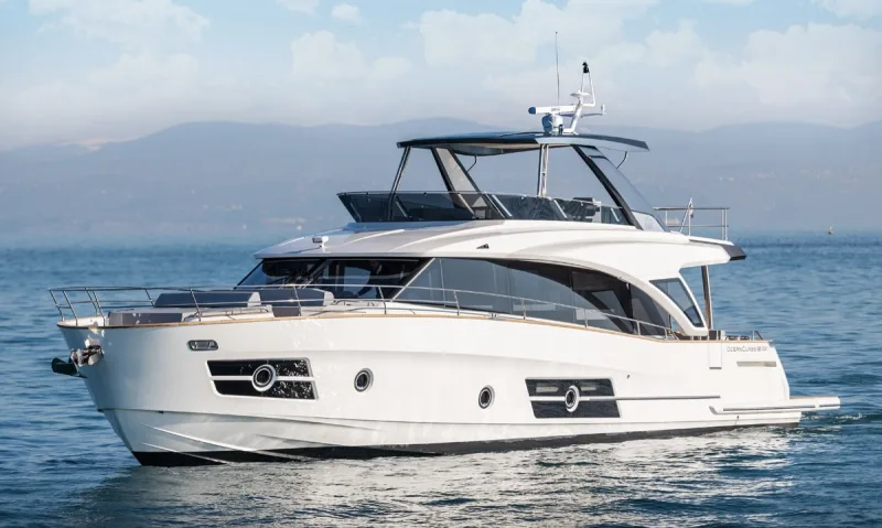 A flybridge motor yacht under way